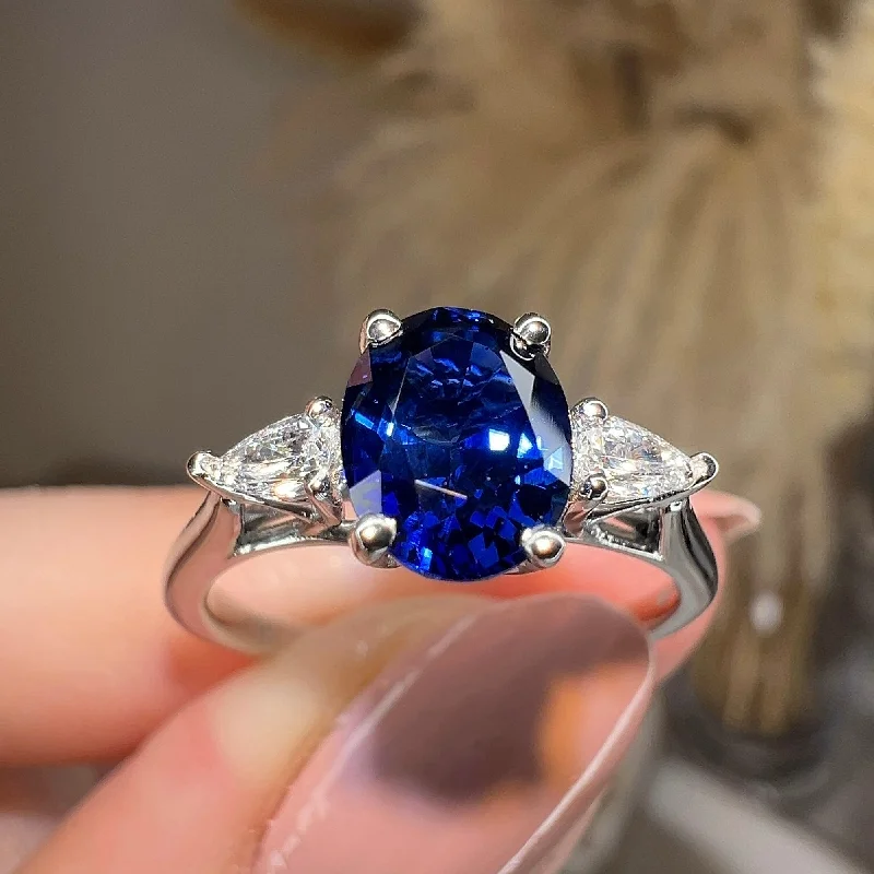 Ladies engagement rings boho vibes-"Gwen" Trilogy 2 Carat Oval Cut Blue Sapphire Pear Shoulders Platinum Engagement Ring